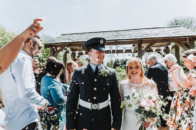 A soldier marrying his bride with confetti flowing