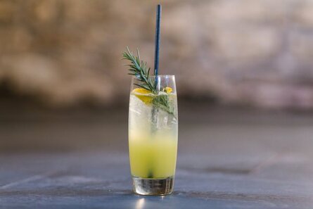 An St Clements Fizz made with Knightor Vermouth, garnished with a sprig of rosemary.