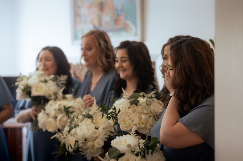 A group of bridesmaids with bouquet of flowers