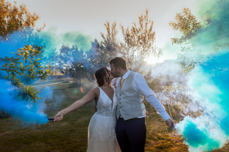 a couple setting of coloured flares in the orchard