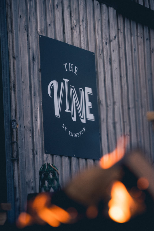 The Vine by Knightor logo located on the entrance to the barn.